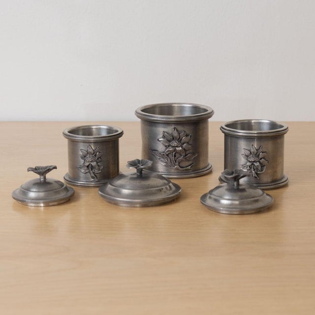 Beautiful set of floral pewter cannisters from France, 1930s. Pewter cannisters and lids with flower detail. Original...