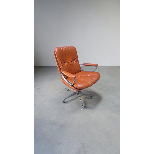 Orange/brick red cowhide office chair, made in Norway by Ring Mekanikk in the 1960s. The chair is height-adjustable...