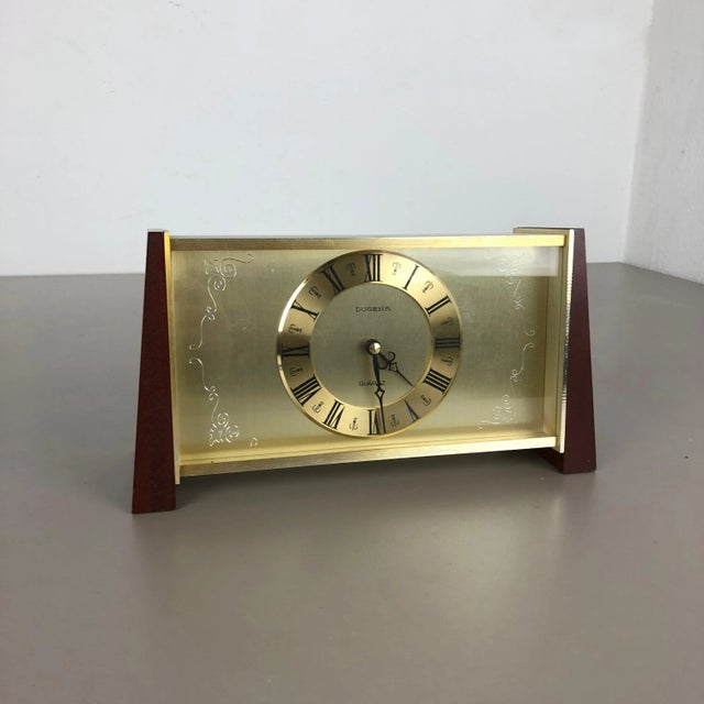 Table clock Origin: Germany Producer: Dugena, Germany Age: 1960s This original wooden table clock was produced in the...