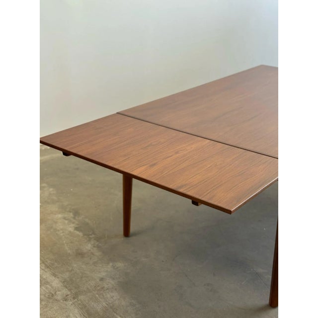 W63 D39 Extended 103 H29 KC24 Leaf W19.5 Teak dining table with completely hidden leaves and angular dining chairs legs....