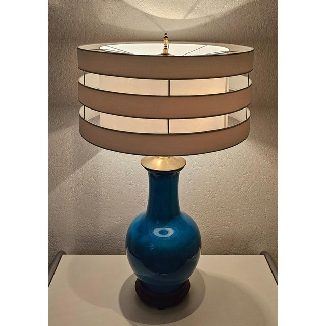 A rare and large Mid Century Modern table lamp by Warren Kessler New York. The lamp is made in blue ceramics, with...