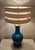 A rare and large Mid Century Modern table lamp by Warren Kessler New York. The lamp is made in blue ceramics, with...