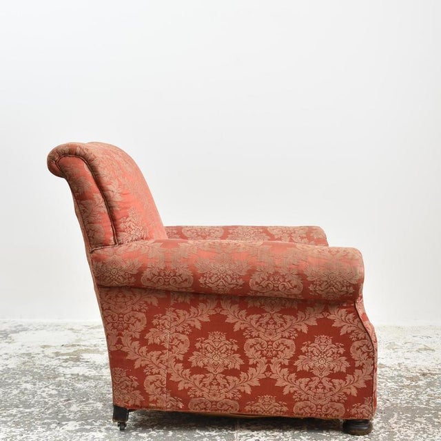 Antique Scroll Arm Deep Seated Armchair An Edwardian antique deep seated armchair with scroll top back and arms. It sits...