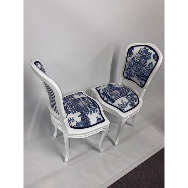 This elegant pair of Louis XV–style side chairs showcases graceful cabriole legs and a clean white finish. They are...
