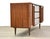 A mid century modern walnut nine drawer dresser with two doors and sculpted details. Professionally refinished. 72.25”...
