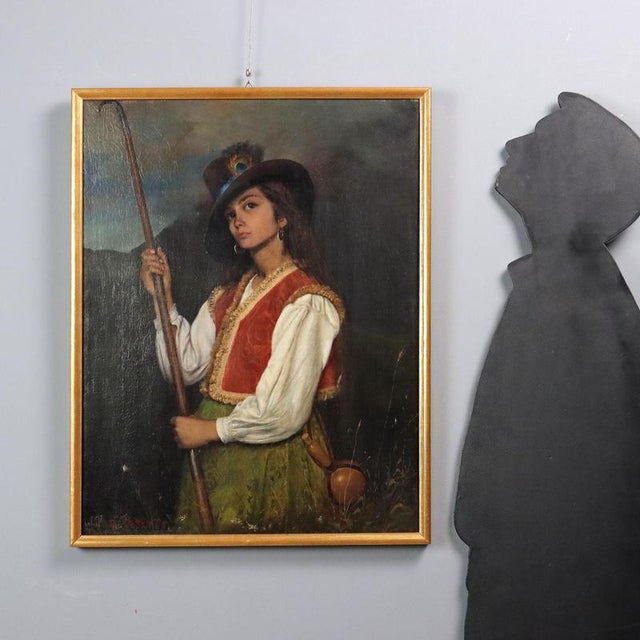 Oil on canvas. A beautiful figure of a young girl in traditional pastoral costume, elegant in her gold-fringed vest, her...
