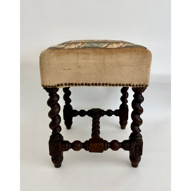 This French antique oak barley twist stool is upholstered in a tapestry on velvet with nailhead trim. Intricately carved...