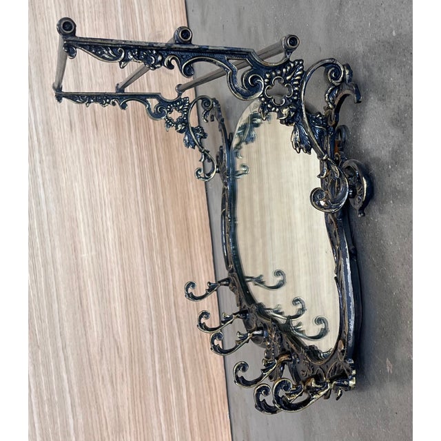 19th French bronze wall-mounted coat rack with mirror and six hangers. Dimensions: Height: 15.75 in (40 cm)Width: 22.25 in...