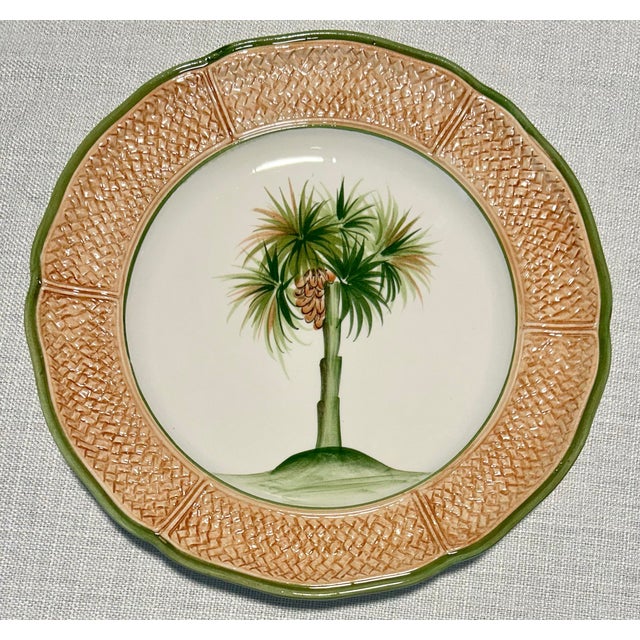 Striking vintage Vietri Italian porcelain plates featuring a tropical coconut palm tree motif framed by an elegant...