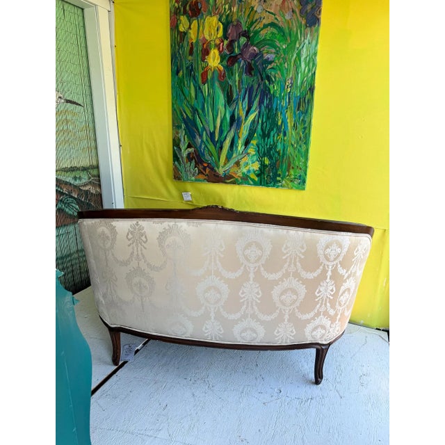 This reupholstered Queen Anne settee is in beautiful condition. Upholstery is edged with two runs of piping where fabric...