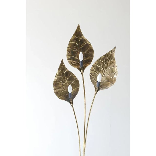 A unique brass 3 leaves floor lamp with a round 30cm base. Each leaf hides a bulb in the back in style of tommaso barbi...