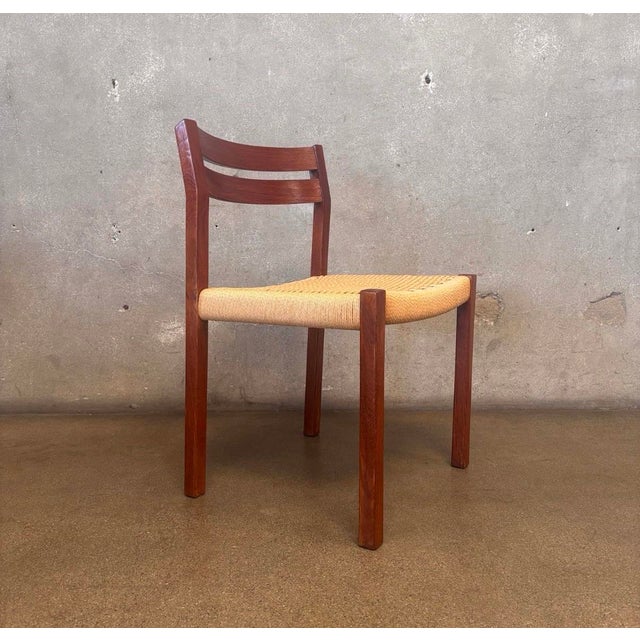 An authentic Danish Modern dining chair by Børge Mogensen for J.L. Møller, crafted in solid teak with clean Scandinavian...