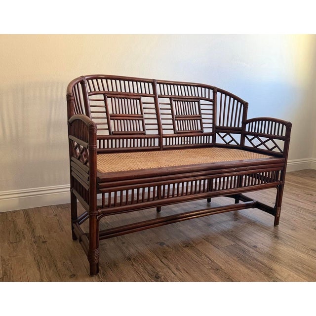 Classic vintage Brighton Pavilion–style bamboo settee featuring elegant Chippendale-inspired fretwork, a gracefully arched...