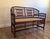 Classic vintage Brighton Pavilion–style bamboo settee featuring elegant Chippendale-inspired fretwork, a gracefully arched...