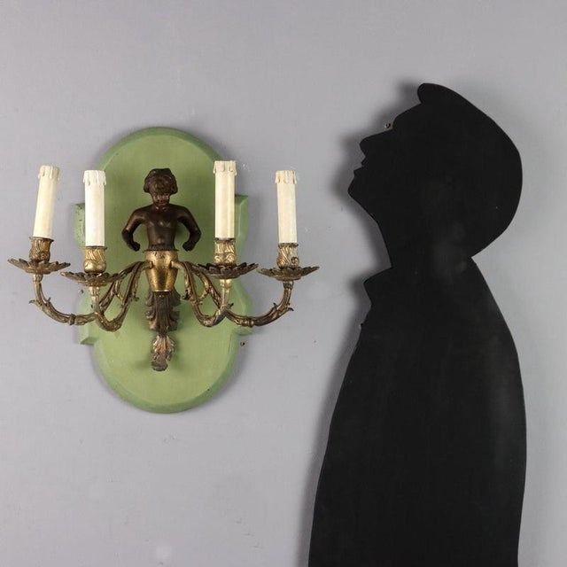 Four-armed golden metal applique. Load-bearing body with bronze sculpture applied to a lacquered wooden panel. Italy, 20th...