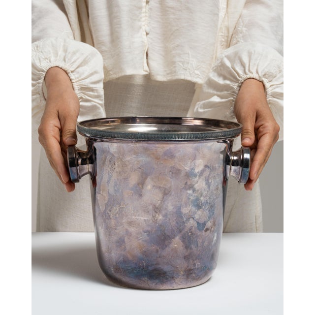 This mid 20th century ice bucket from France is finished in eggplant, worked in silver. Its form follows honest, well-...