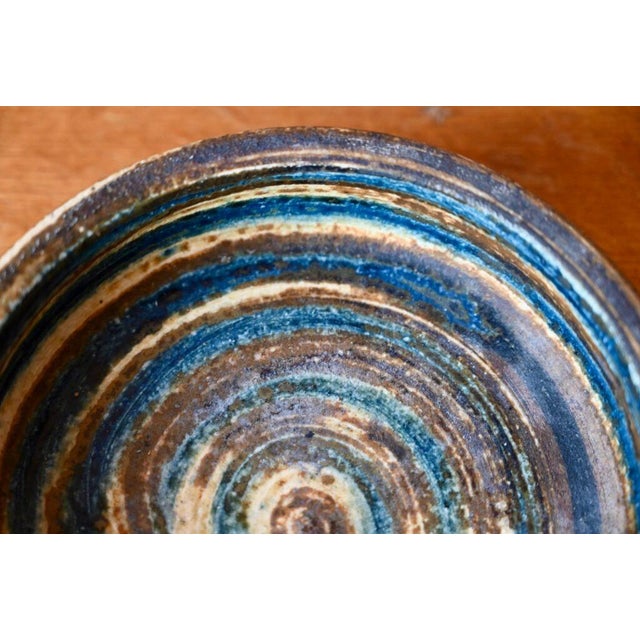 This beautiful Danish bowl from the 1960s is made of stoneware, partially glazed, in shades of gray to blue. The potter...