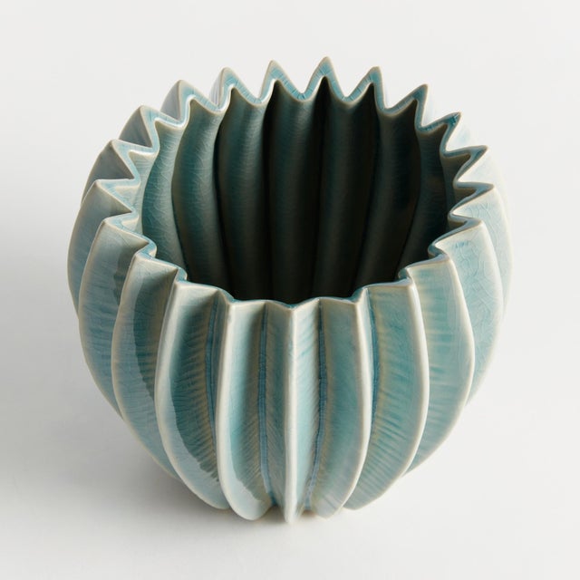 With a rounded form, deep ribbing and thickly applied glaze, this natureinspired pot is a work of art. The handfinished...