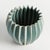 With a rounded form, deep ribbing and thickly applied glaze, this natureinspired pot is a work of art. The handfinished...