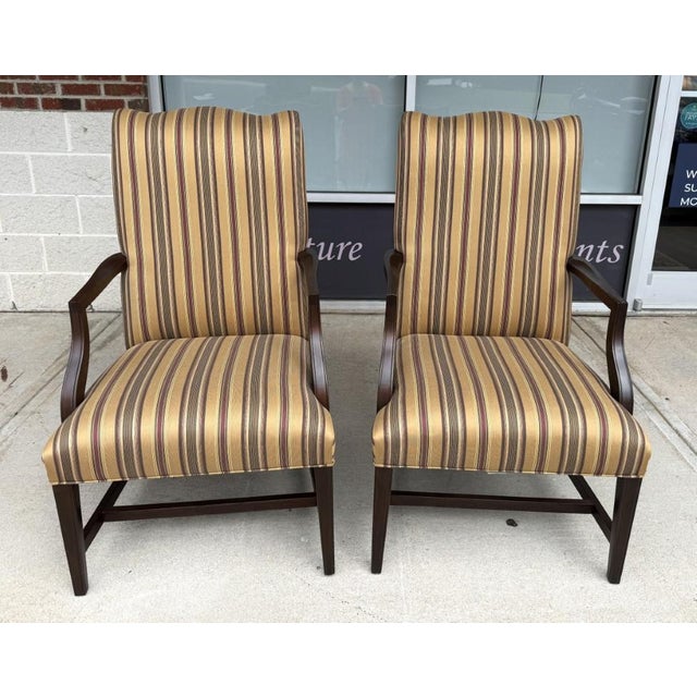 This pair of Ethan Allen High Back Arm Chairs features tall upholstered backs, gently curved wood arms, and classic...