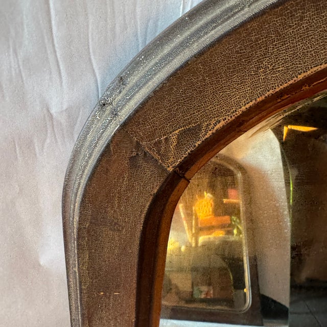 Substantial late 19th century American wall mirror featuring a classic ogee-top silhouette and original mirror plate. The...