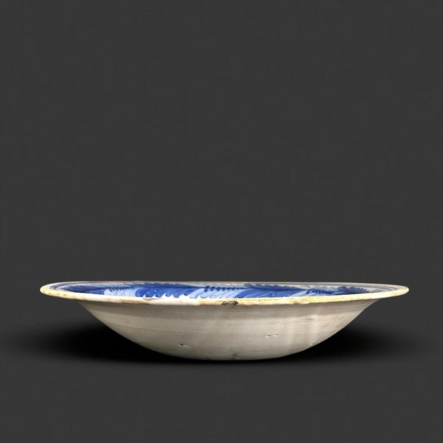 Elegant Spanish blue and white faience charger from Talavera de la Reina, dating to the 18th century, hand-painted in...