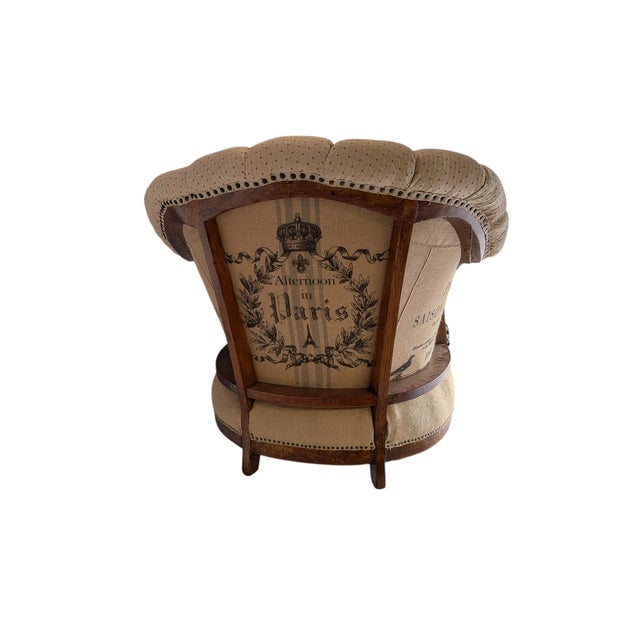 Mid-1900 vintage barrel back armchair refined in a deconstructed style with a tufted barrel back and is exceptionally...