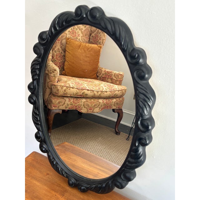 Pretty black resin mirror with the look of carved wood. This mirror is lightweight and ready to hang. Please see condition...