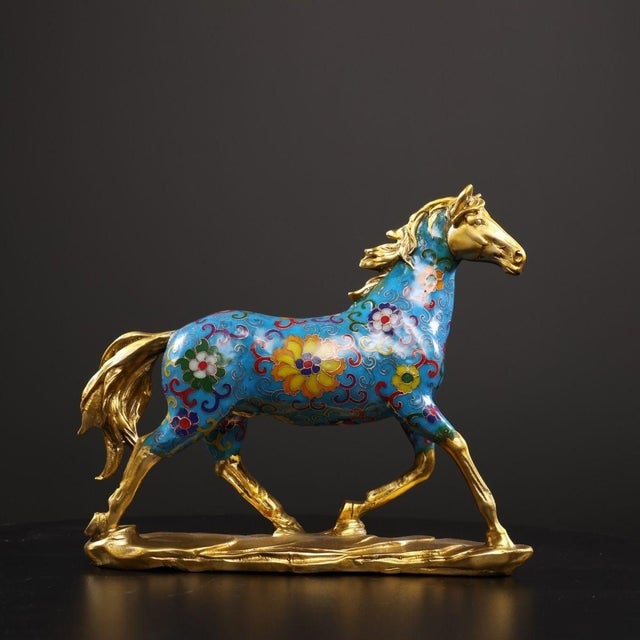 This elegant sculpture depicts a horse in a dynamic, prancing pose, a traditional symbol of success, perseverance, and...