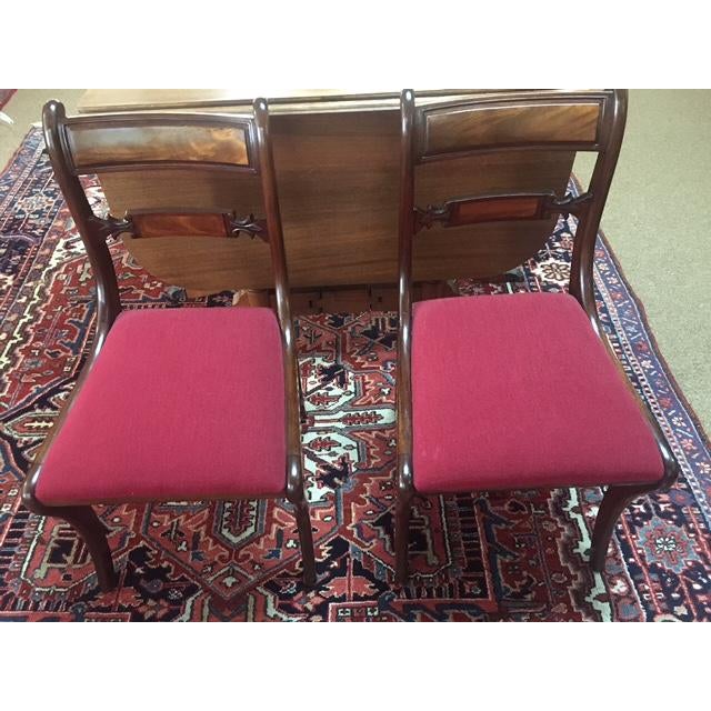 This unique Sheraton style mahogany dining table features swing legs which is perfect in case you need more space at times...