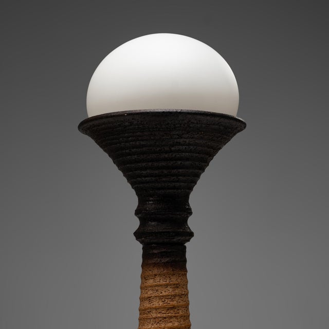 This ceramic table lamp was produced by Doria Leuchten in Germany during the 1970s. with its substantial proportions,...