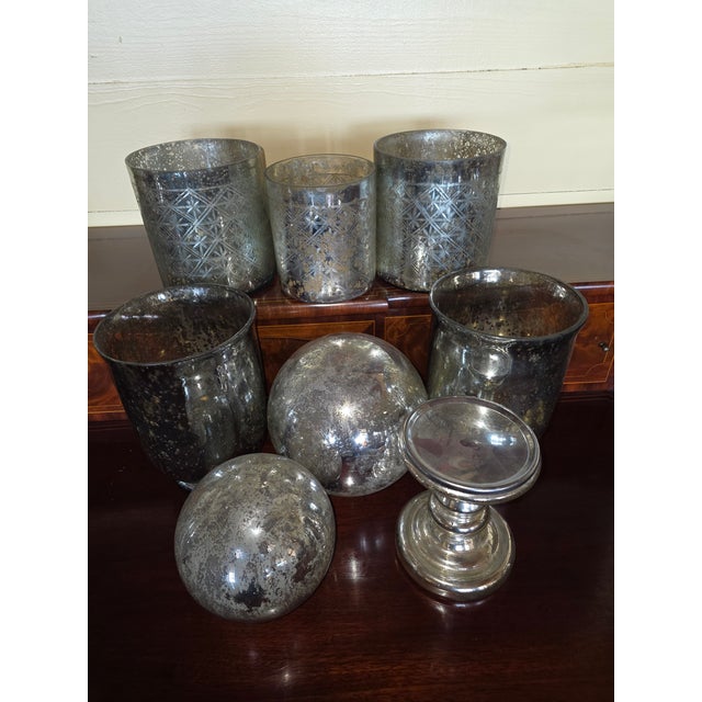 Collection of 8 pieces of mercury glass two spheres, three etched cylinders, one pedestal, and two vases.
