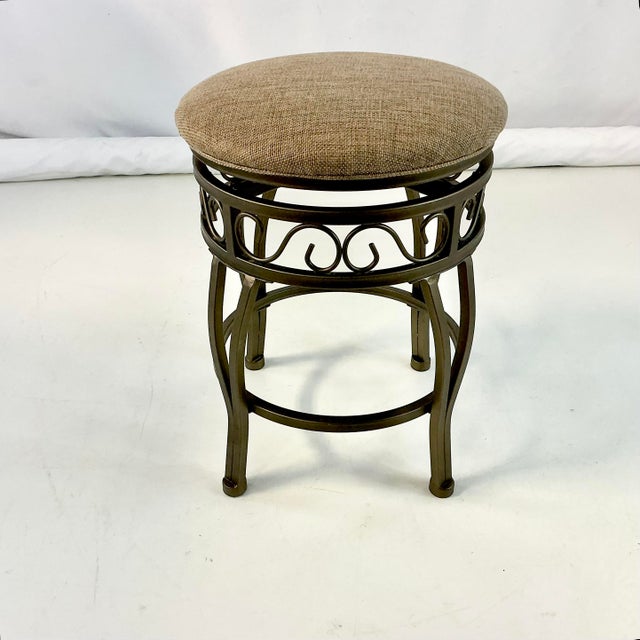 We love this little counter stool. It’s from the 1990s and features a swivel cushioned top that upholstered in a tweed...