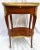 Elegant French Transitional Louis XV/XVI oval marquetry side table, adorned with ormolu mounts and a decorative gallery....