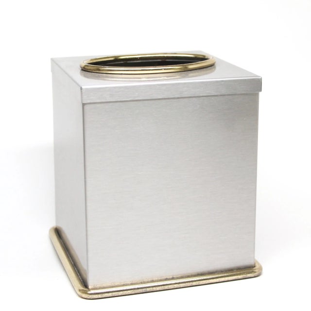 Vintage tissue box cover made of brushed steel with a polished brass trim. They are unused old new stock. This is...