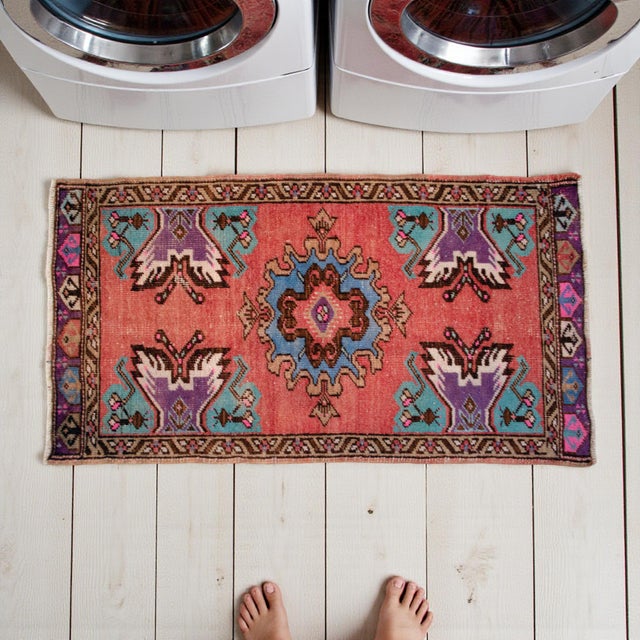 This authentic hand-knotted Oushak rug brings a vibrant touch of Aegean Anatolian heritage to any compact space. Its sun-...