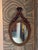 Louis XV style giltwood oval mirror, the frame carved with running ribbon and beaded borders, surmounted by a crossed...