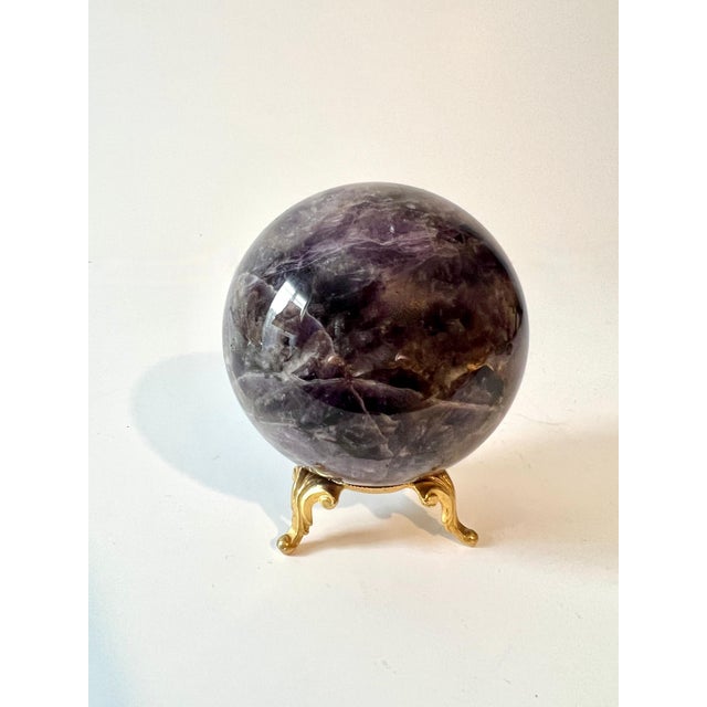 A beautiful Lapis sphere / Paperweight on a gilt stand. The piece has beautiful coloring and is a compliment to any side...