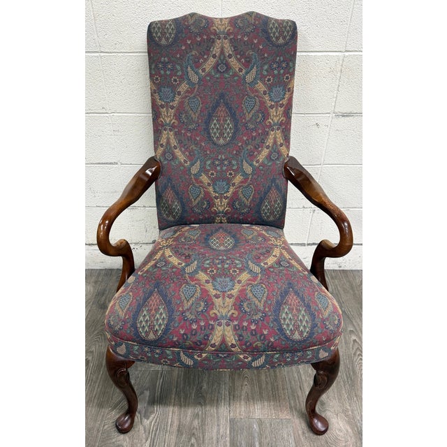 This is a gorgeous vintage Queen Anne style library chair crafted with a richly finished mahogany frame featuring graceful...