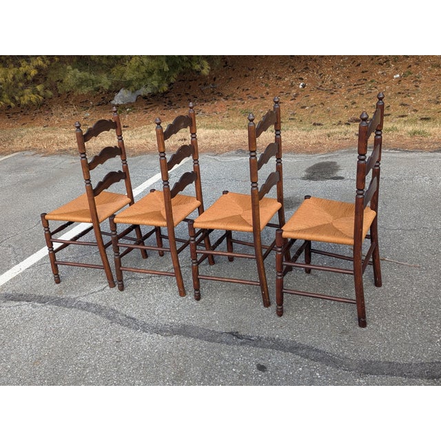 Bring timeless farmhouse or French Country charm to your dining room with this handsome set of four vintage ladder back...