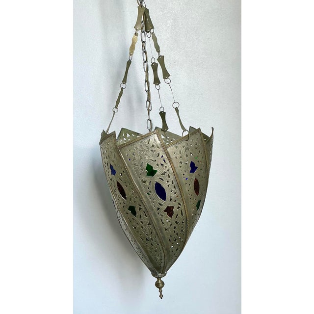 This enchanting Moroccan-style lantern is a masterwork of artisanal metalcraft and exotic design. Featuring an intricately...