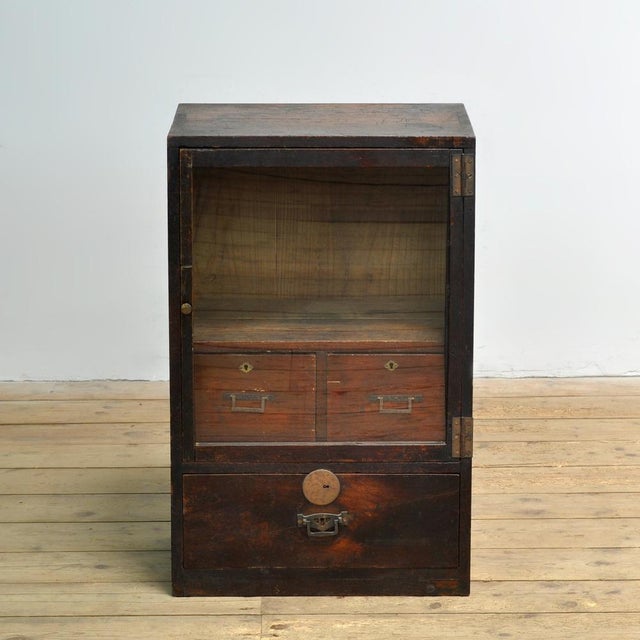 This small Japanese cabinet, manufactured around 1920, is a characterful piece of furniture with an understated appearance...