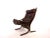 A Siesta armchair in a beautiful, rich chocolate brown with an additional cushion in the headrest and armrests. The...