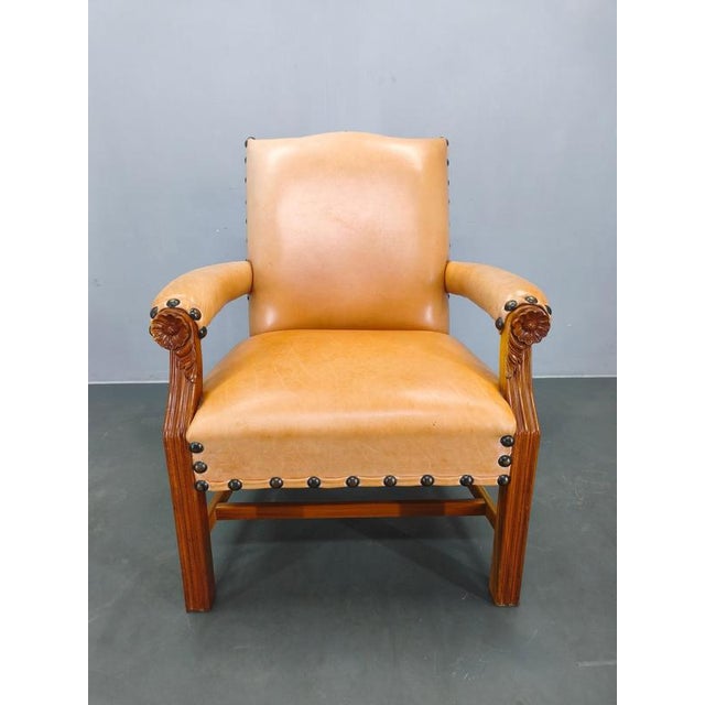 Large antique Danish leather armchair from the early 20th century. This beautifully crafted piece features original...