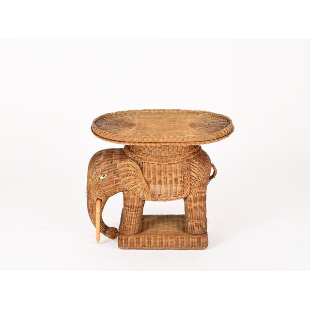 Wonderful and rare midcentury elephant-shaped side table with removable tray fully made in hand-woven wicker. This stylish...
