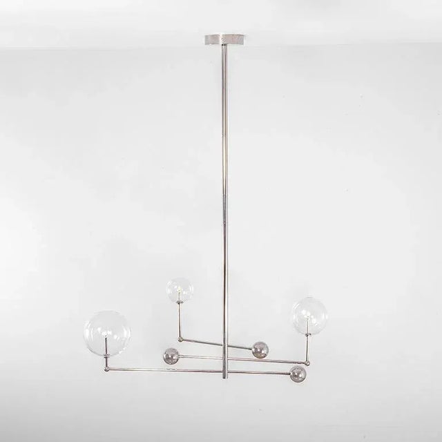 Polished nickel 3 arm contemporary chandelier by schwung dimensions: d 25 x w 128.2 x h 178 cm materials: solid brass,...