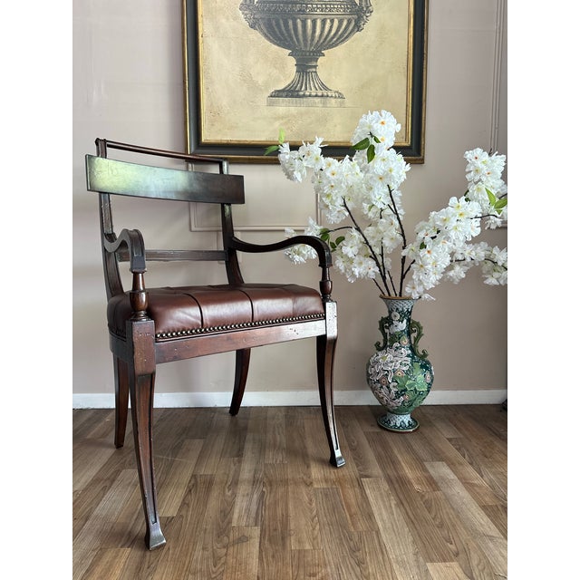 Elegant Henredon Acquisitions armchair with classic Regency influence, featuring a shaped open back, graceful scrolling...