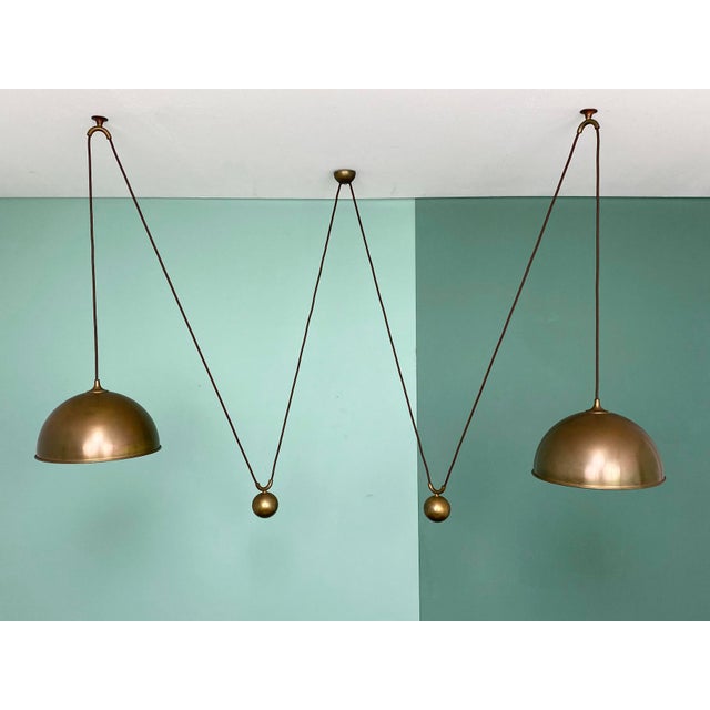 Posa Double Pendulum Ceiling Lamp in Brass by Florian Schulz, Deutschland, 1960s, in Very Good conditions. Designed 1960...