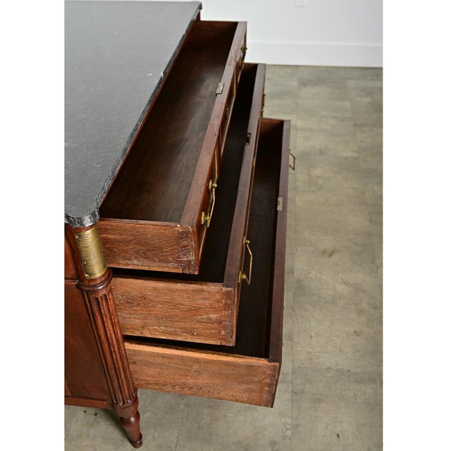 Dimensions: 32” H x 49” W x 21 ⅝” D A gorgeous Louis XVI style, marble-topped walnut commode from France (late 19th...