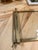 Elegant rectangular serving tray featuring a brass frame, clear glass base, and raised handles. The brass displays a warm...
